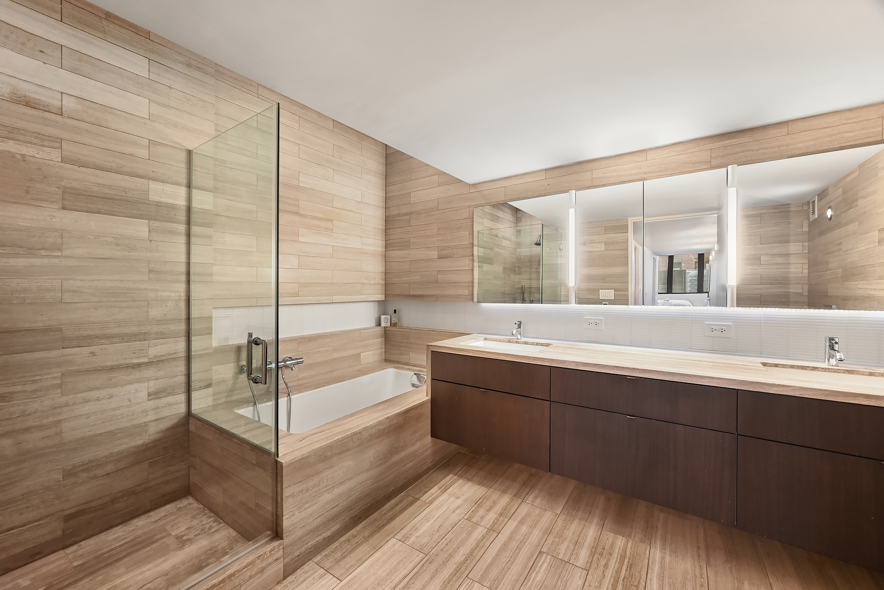 421 Hudson Street, Unit 318 Manhattan, NY 10014 - Photo 7 of 12 a bathroom with a bathtub and a double vanity sink
