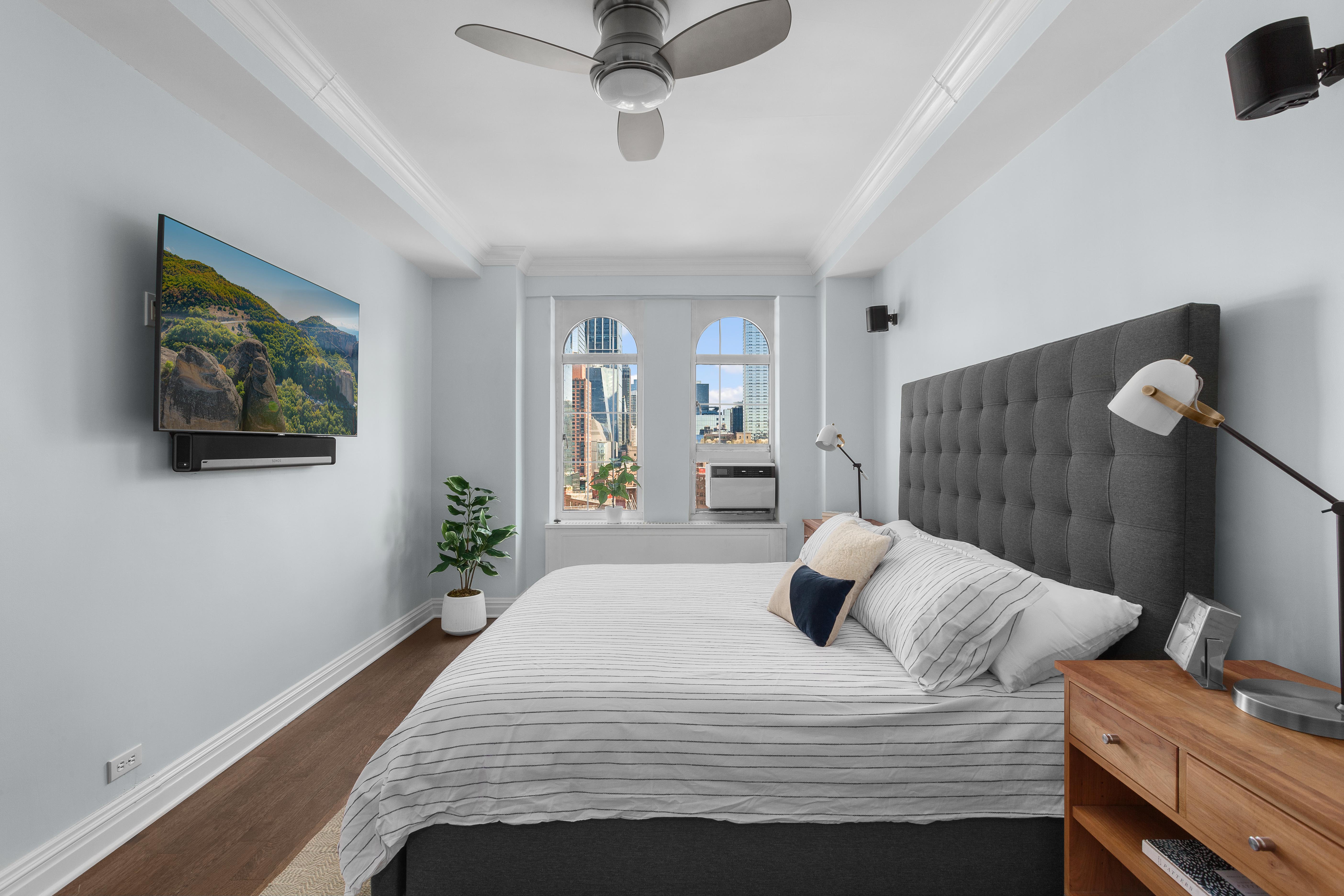 470 West 24th Street, Unit 16H Manhattan, NY 10011 - Photo 8 of 13 a bedroom with a bed and a flat tv screen