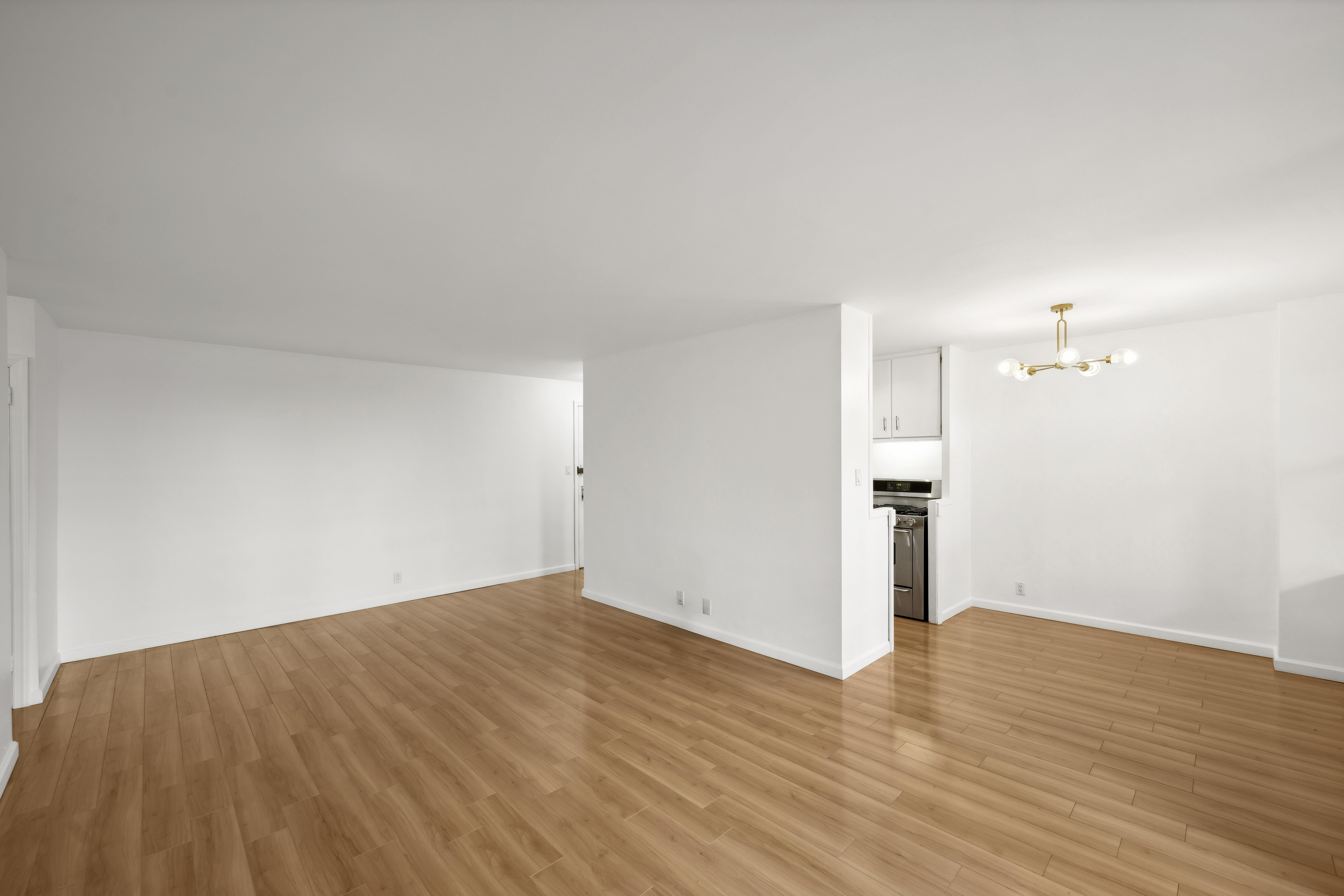 303 West 66th Street, Unit 2AE Manhattan, NY 10023 - Photo 4 of 15 a view of empty room with wooden floor