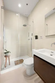 a bathroom with a sink a toilet and a shower