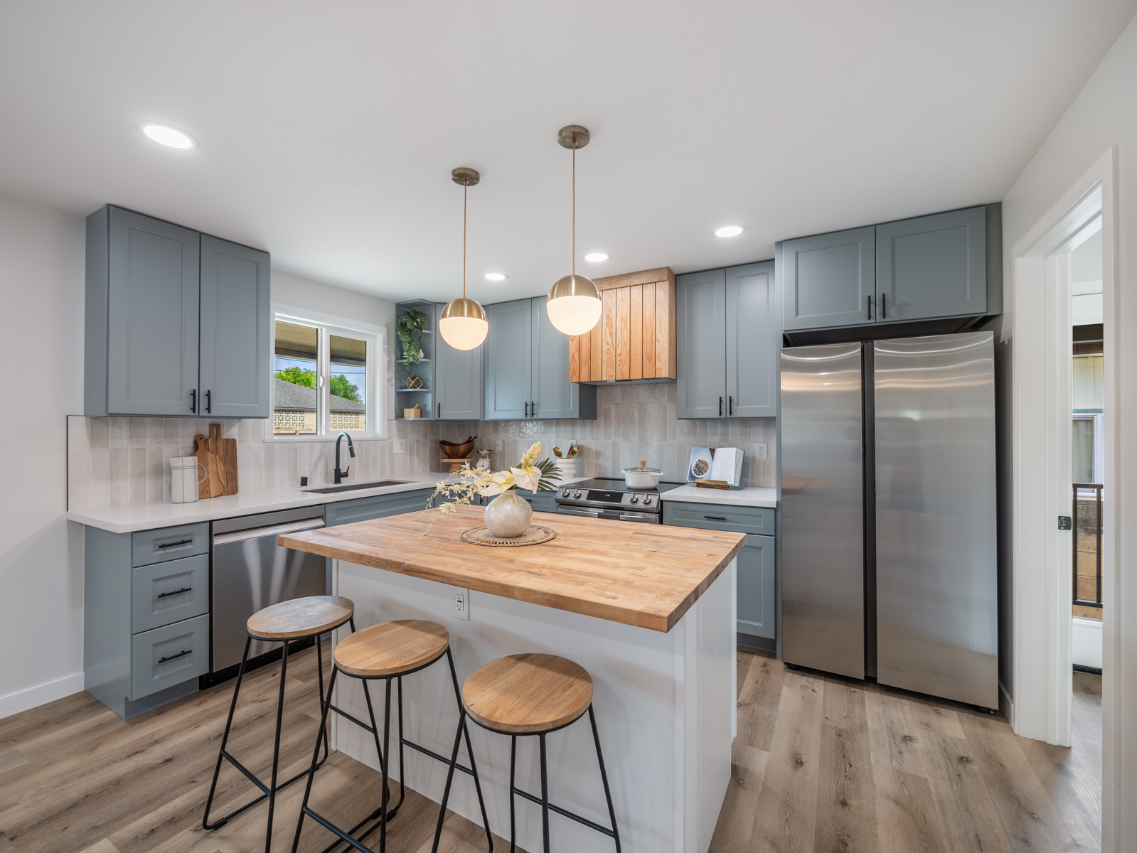 45-561 Paleka Road, Unit C Kaneohe, HI 96744 - Photo 2 of 27 a kitchen with granite countertop a sink a center island and stainless steel appliances
