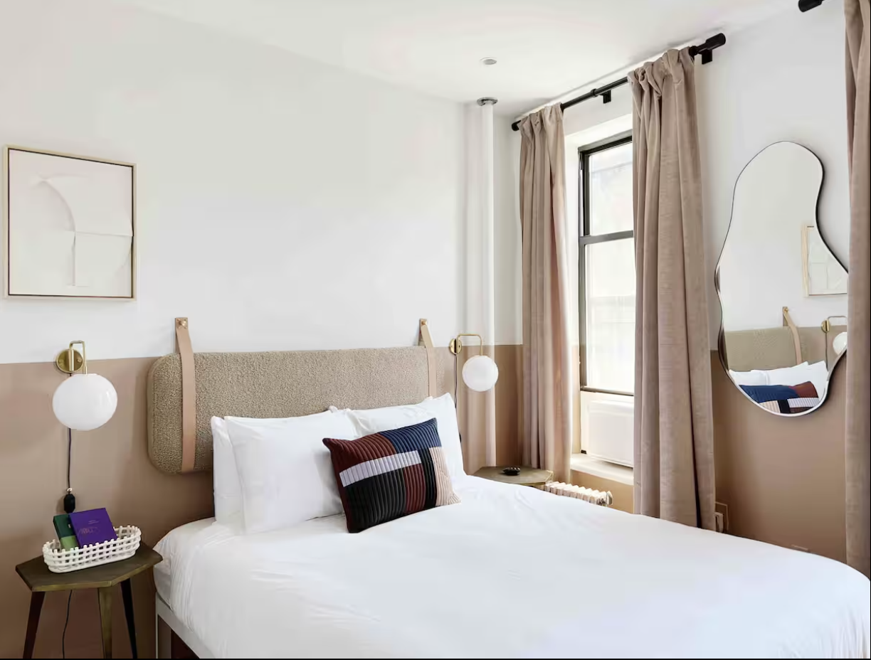 9 Spring Street, Unit 23 Manhattan, NY 10012 - Photo 4 of 7 a bedroom with a bed and dresser with mirror