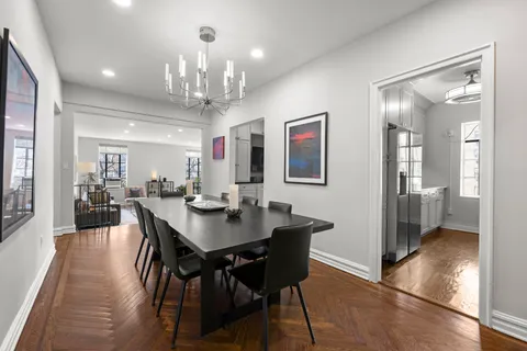 a view of a a dining room with furniture window and wooden floor