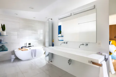 a bathroom with a sink mirror and a bathtub
