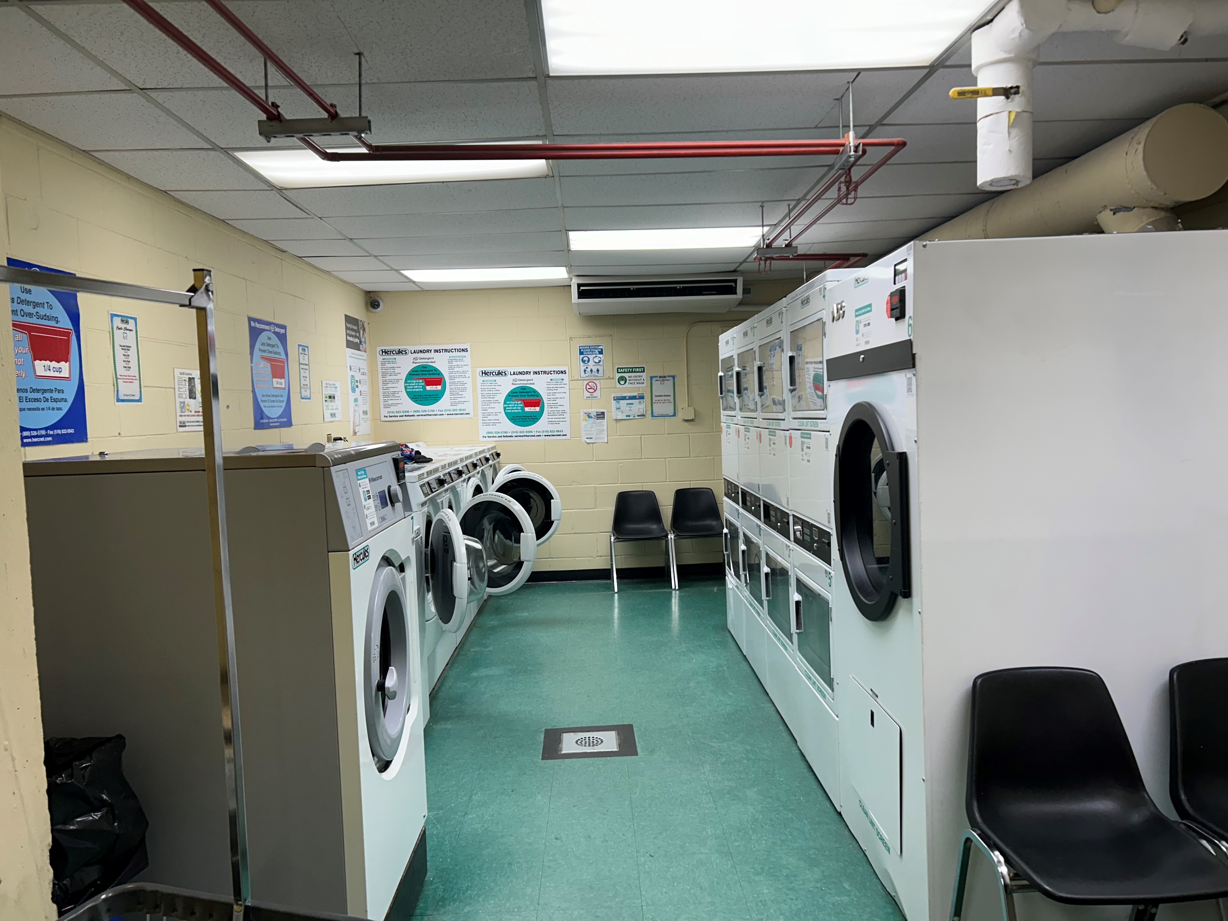 411 East 53rd Street, Unit 11K Manhattan, NY 10022 - Photo 15 of 19 a utility room with multiple dryer and washer