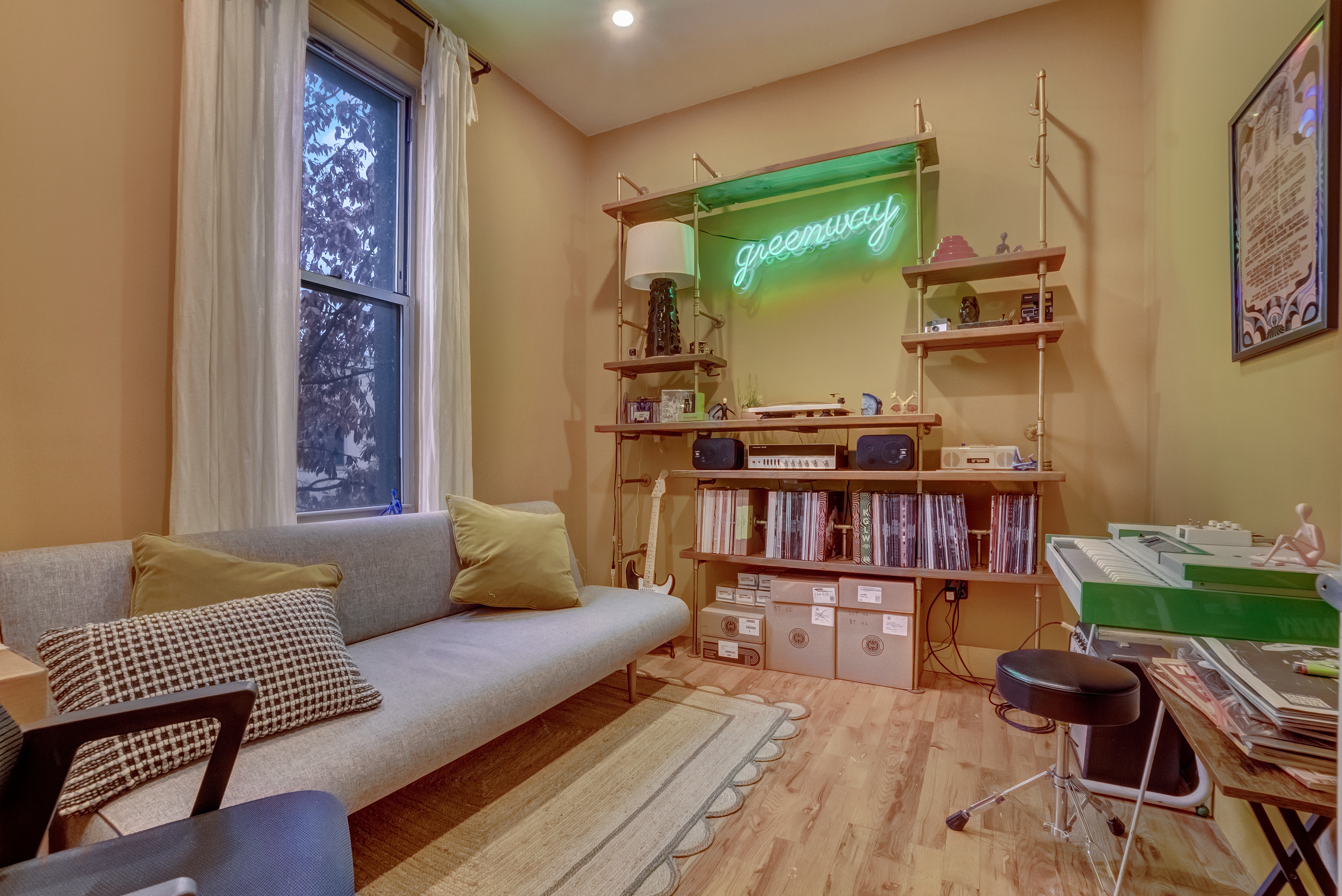 a living room with furniture and a book shelf