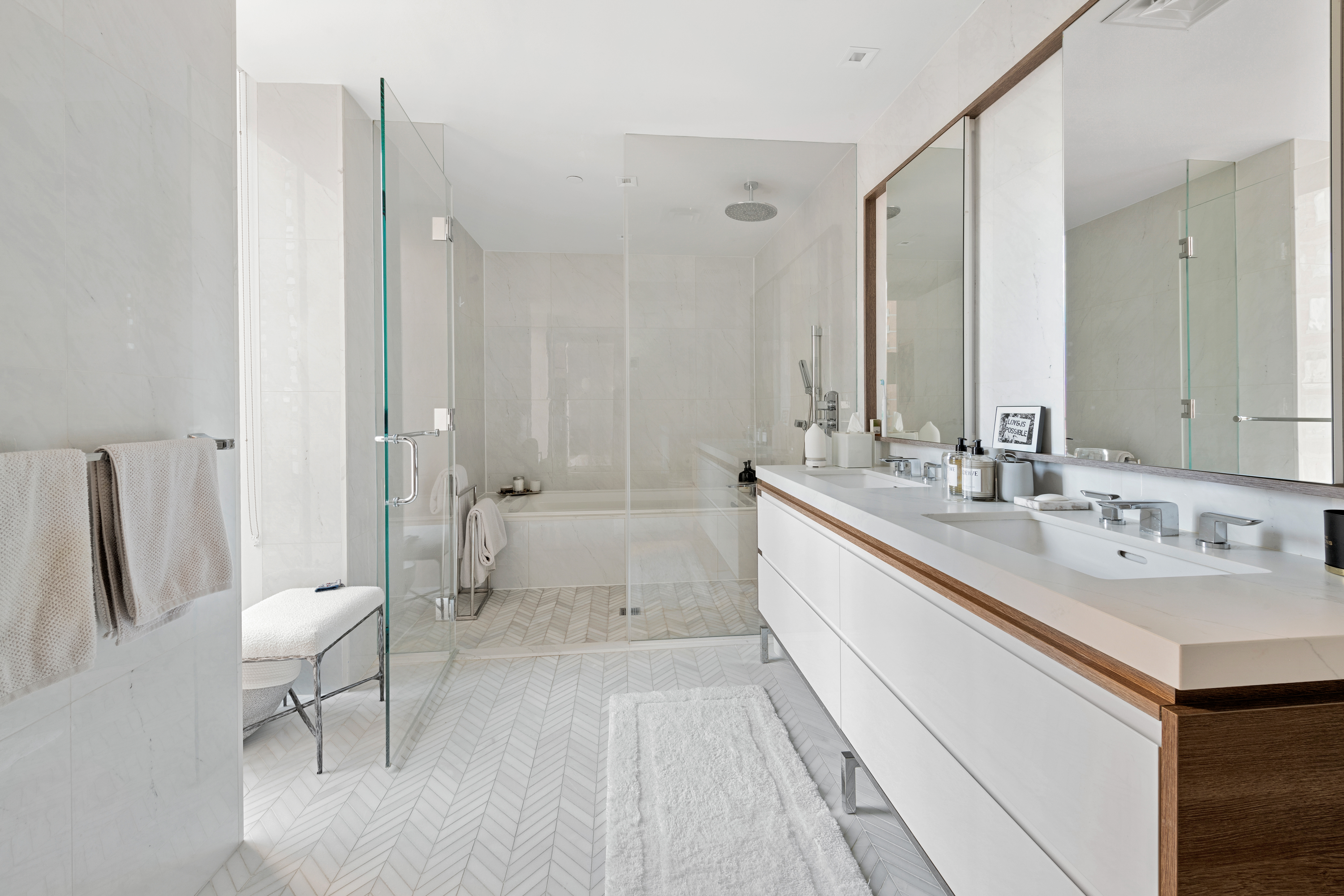 505-513 West 43rd Street, Unit PHG Manhattan, NY 10036 - Photo 11 of 20 a bathroom with a double vanity sink a toilet and a bathtub