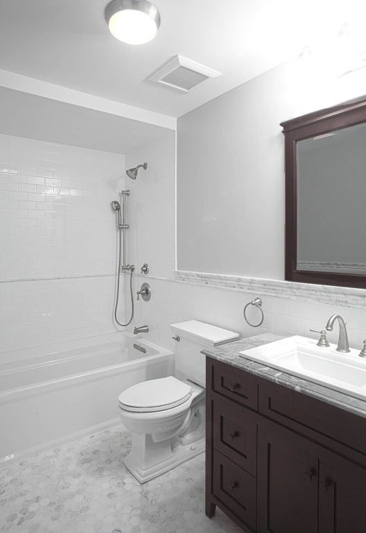 148 Luquer Street, Unit 2 Brooklyn, NY 11231 - Photo 10 of 22 a bathroom with a granite countertop sink toilet a mirror and shower