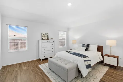 a bedroom with a bed and a couch