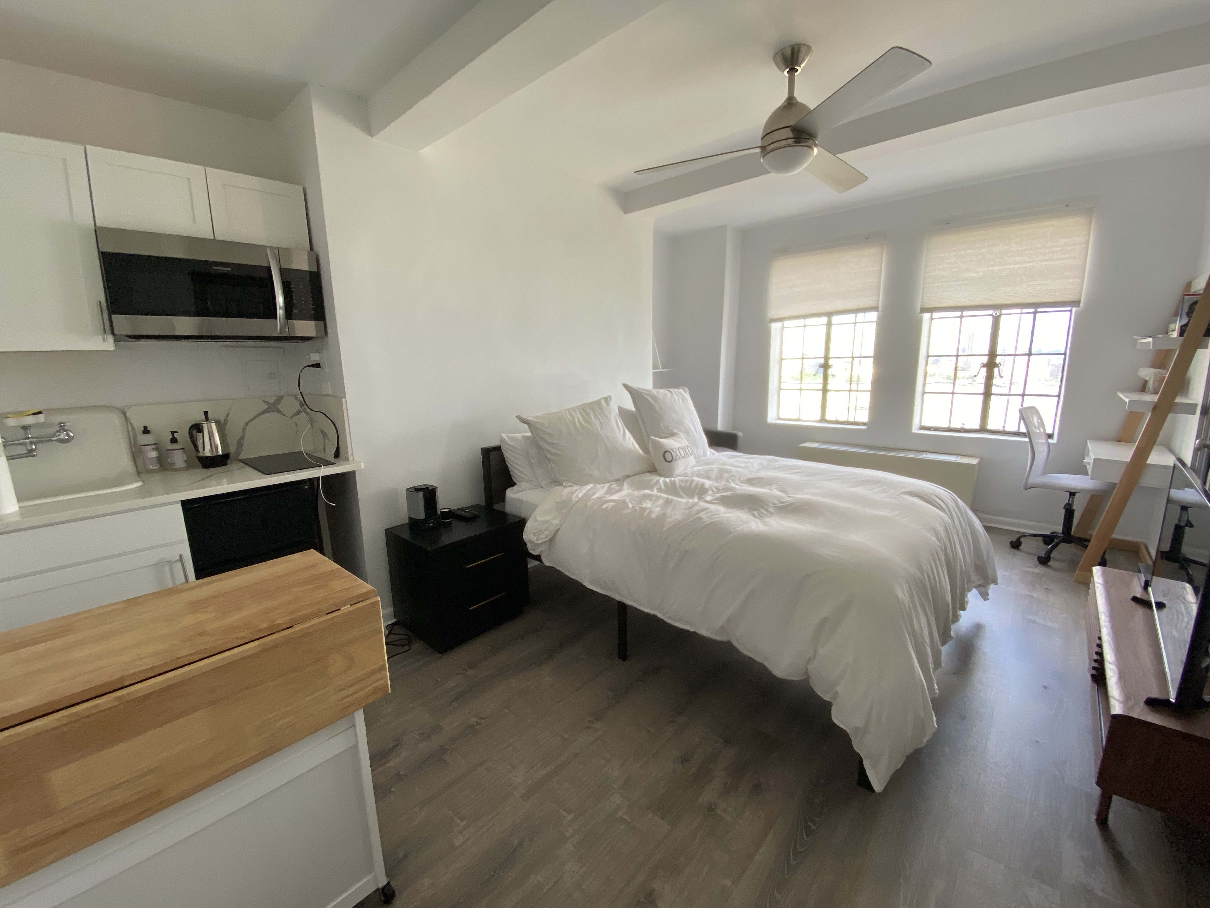 a bed room with a bed and a television