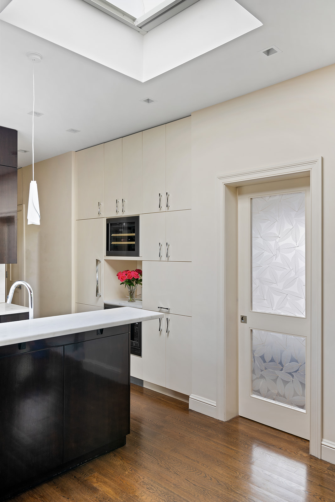 77 Perry Street, Unit 6CD Manhattan, NY 10014 - Photo 8 of 16 a kitchen with cabinets and wooden floor