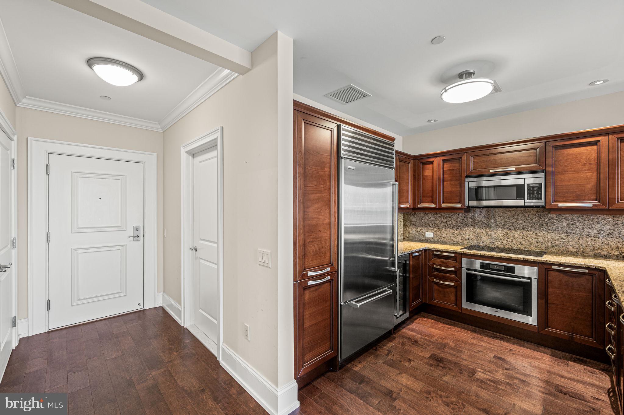 50 South 16th Street, Unit 4503 Philadelphia, PA 19103 - Photo 5 of 31 a kitchen with stainless steel appliances granite countertop a refrigerator and a stove top oven