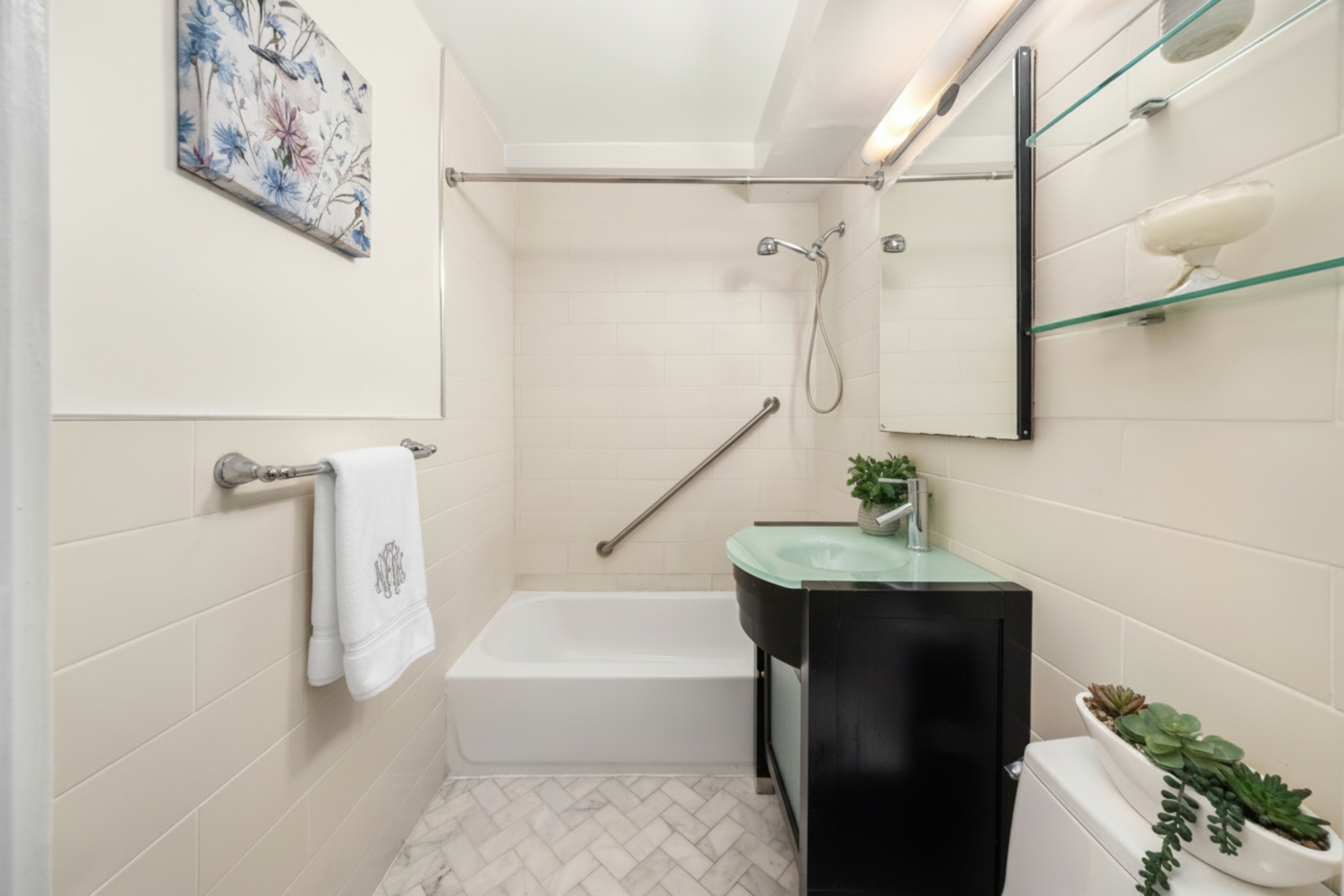 233 East 70th Street, Unit 8T Manhattan, NY 10021 - Photo 7 of 9 a bathroom with a sink a toilet and shower