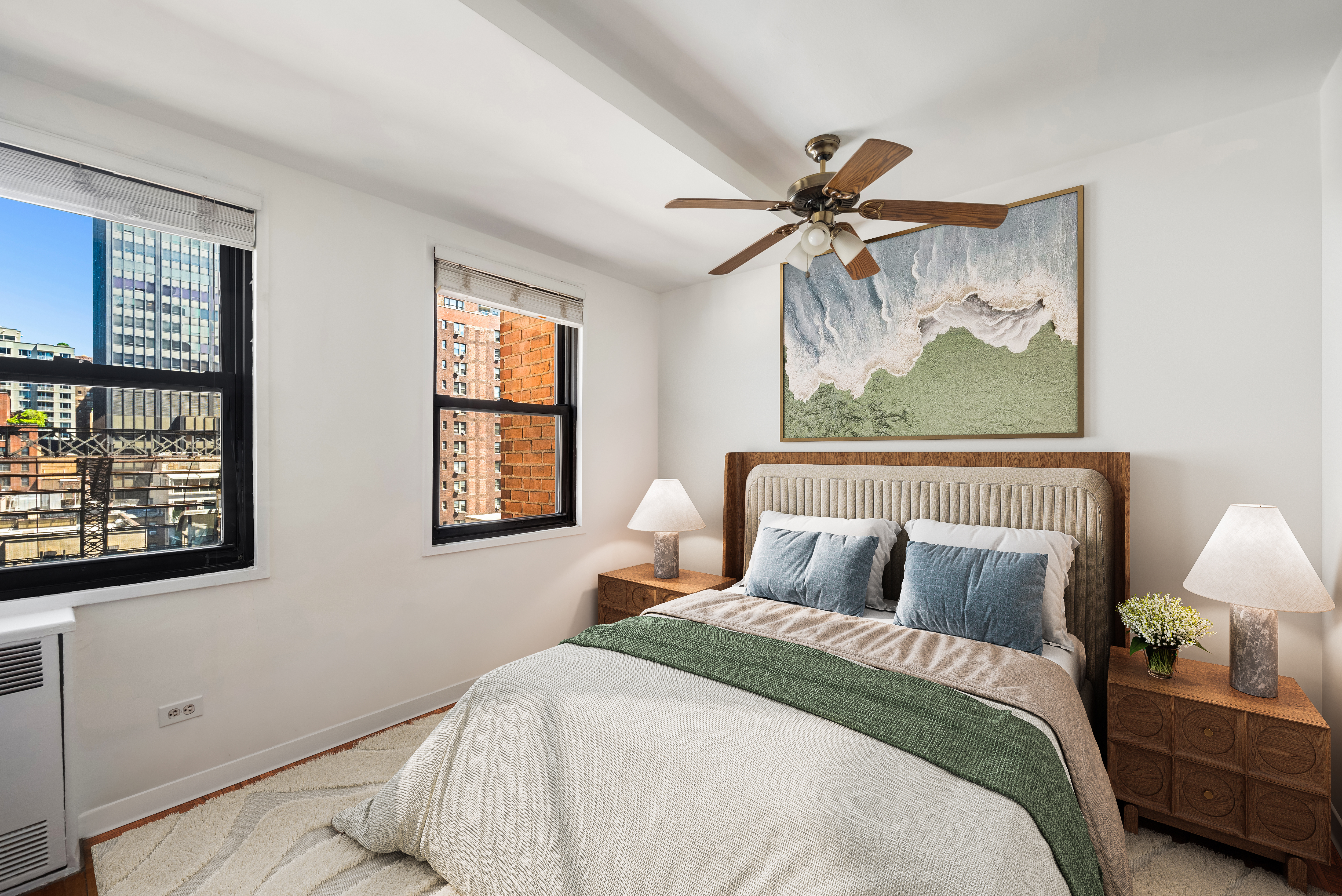 347 East 53rd Street, Unit 9C Manhattan, NY 10022 - Photo 5 of 10 a bedroom with a bed and a painting on the wall