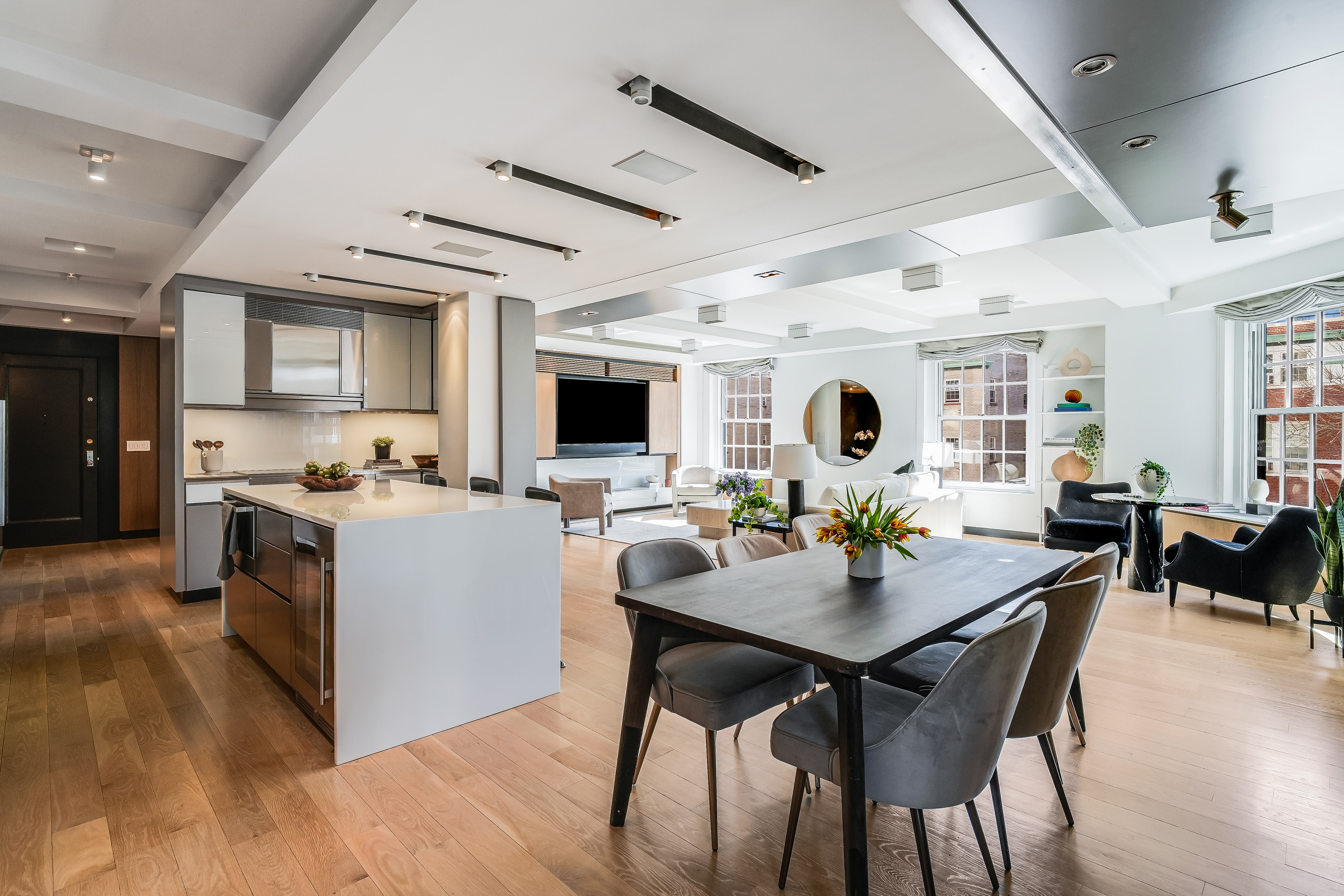 1 5th Avenue, Unit 5GH Manhattan, NY 10003 - Photo 7 of 26 a kitchen with a dining table chairs and stove