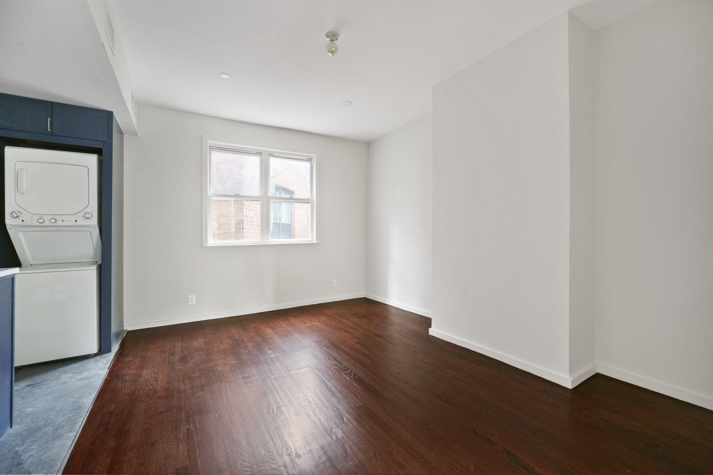 441 Metropolitan Avenue, Unit 1 Brooklyn, NY 11211 - Photo 10 of 11 an empty room with wooden floor and windows