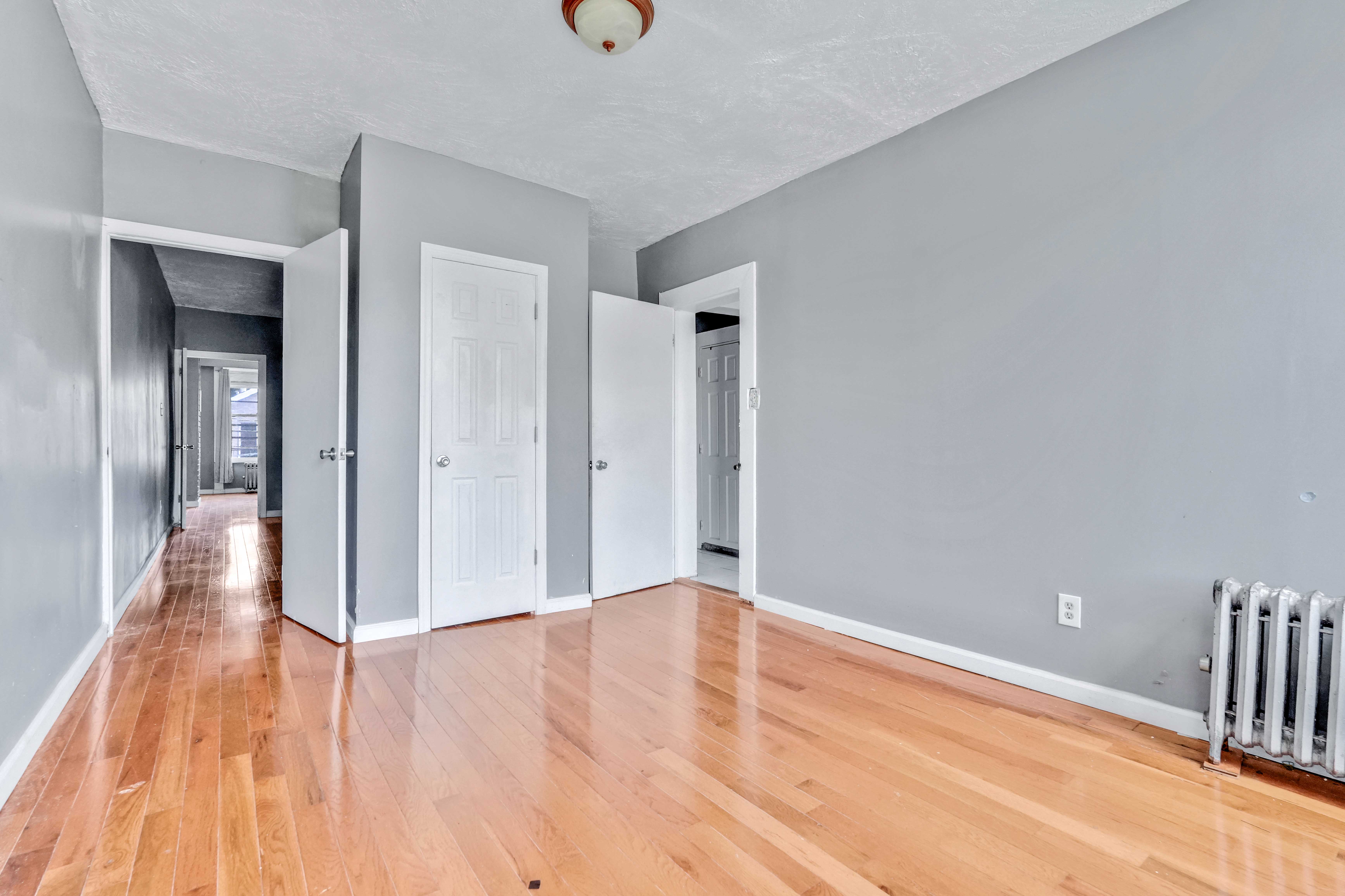610 Ashford Street Brooklyn, NY 11207 - Photo 11 of 28 a view of empty room with wooden floor