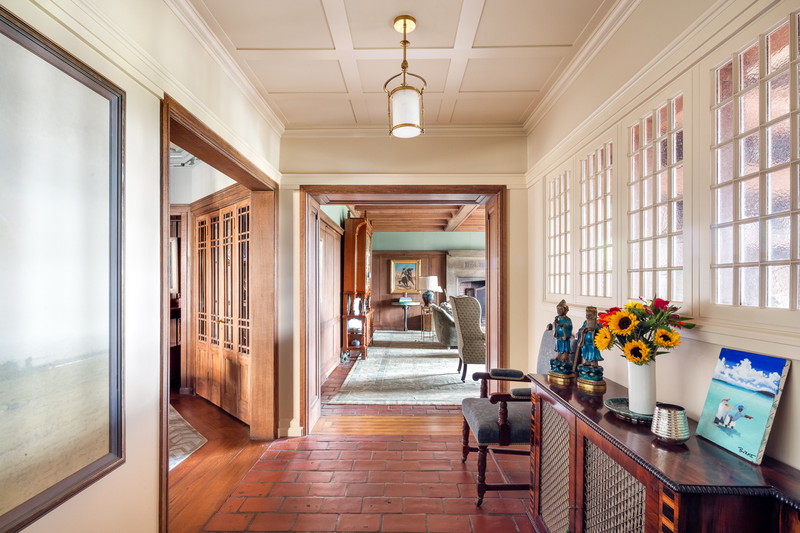 41 Central Park West, Unit 11A Manhattan, NY 10023 - Photo 9 of 17 a view of a hallway to a livingroom with furniture wooden floor windows and a chandelier