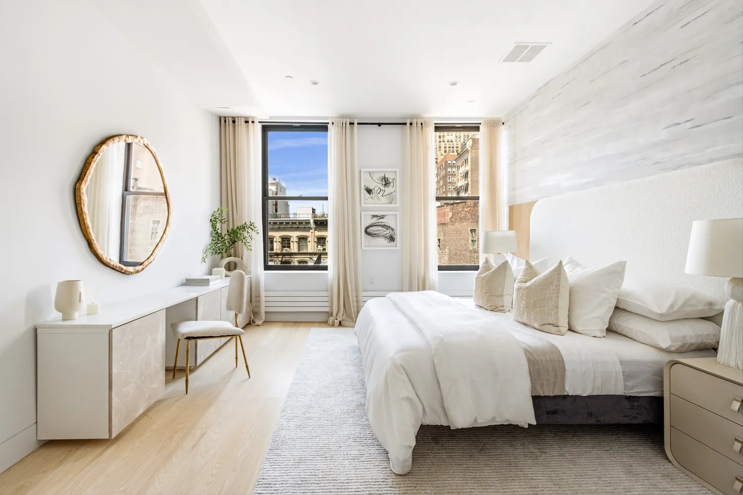 a bedroom with a bed a mirror and a large window