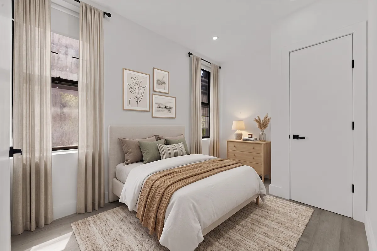 301 East 90th Street, Unit 4C Manhattan, NY 10128 - Photo 2 of 11 a bedroom with a bed and painting on the wall