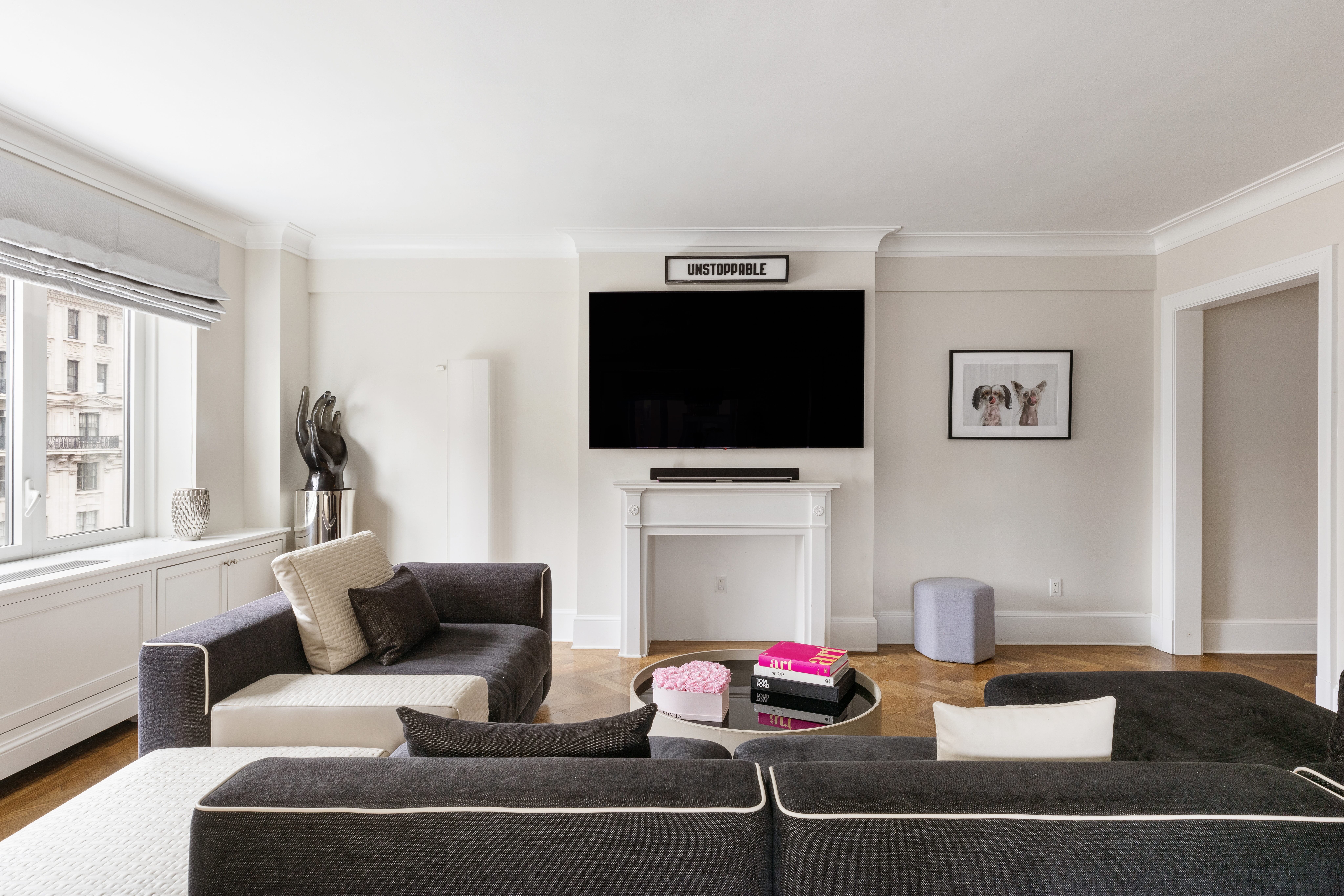 530 Park Avenue, Unit 14D Manhattan, NY 10065 - Photo 2 of 12 a living room with furniture and a flat screen tv