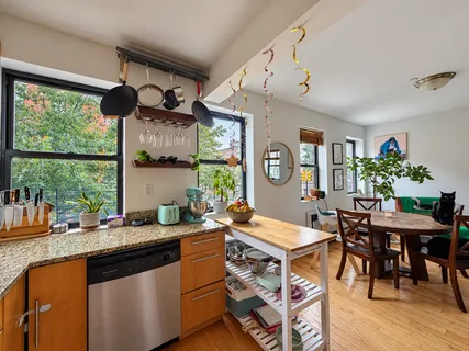 a kitchen with a table chairs stove and cabinets