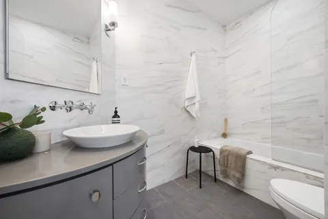 a bathroom with a sink a toilet and bathtub