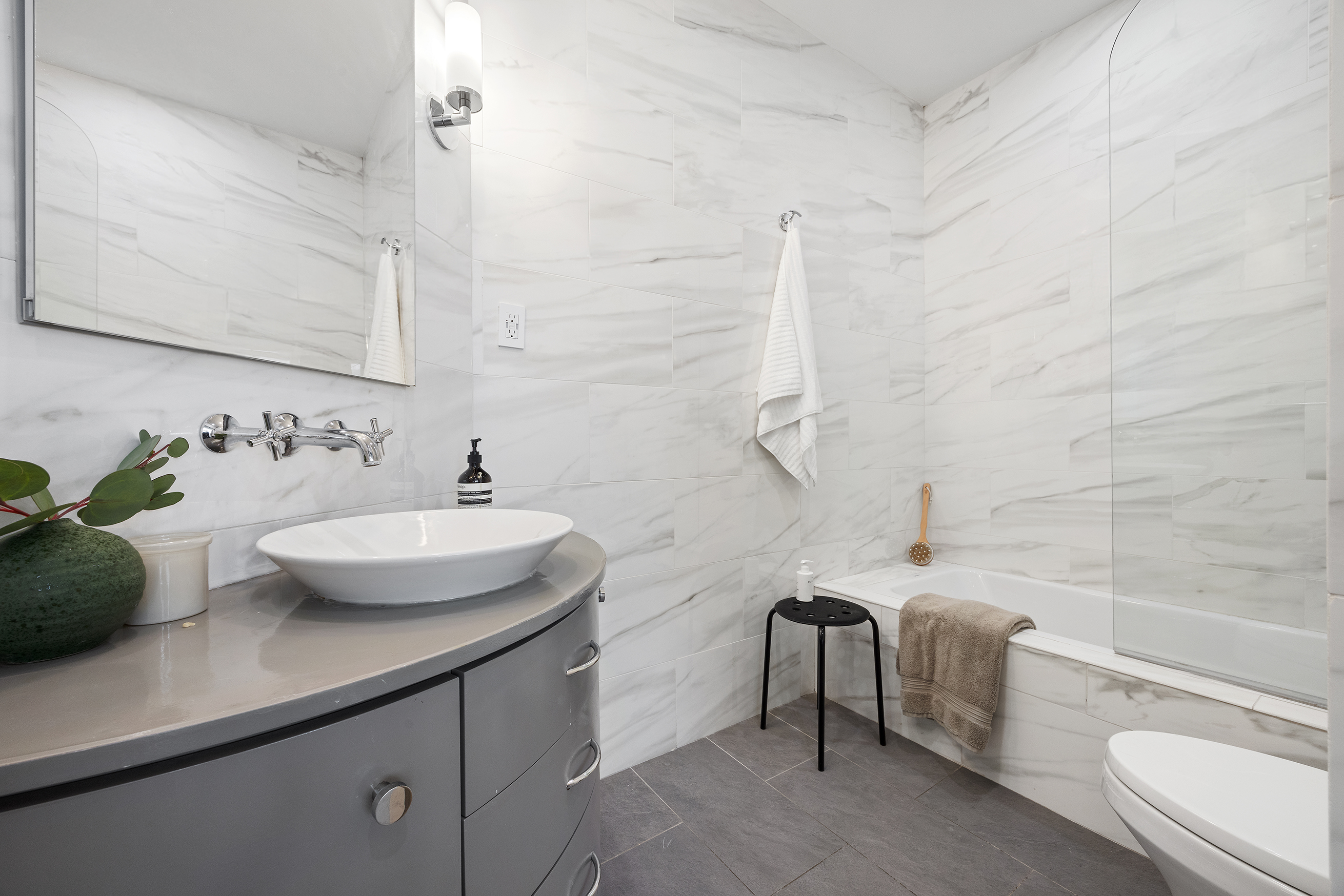 100 Reade Street, Unit 3C Manhattan, NY 10013 - Photo 6 of 9 a bathroom with a sink a toilet and bathtub