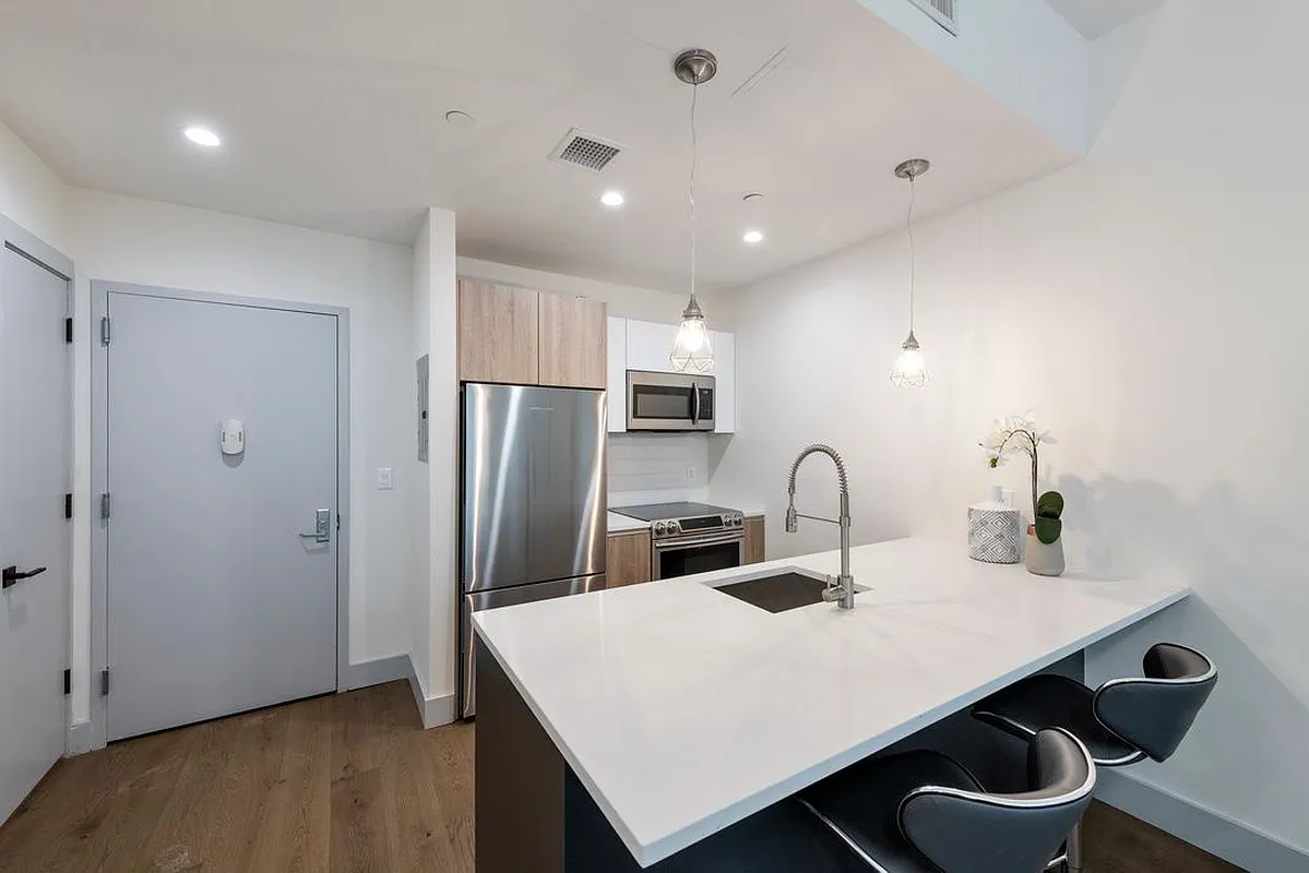 a kitchen with kitchen island a sink appliances and cabinets