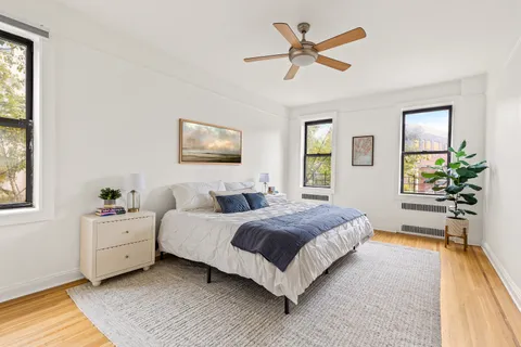 a spacious bedroom with a bed and a chandelier