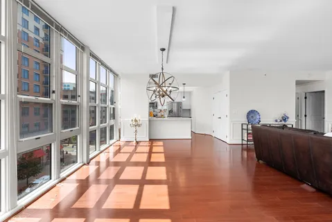 a view of a kitchen with stainless steel appliances granite countertop a sink a stove and a refrigerator