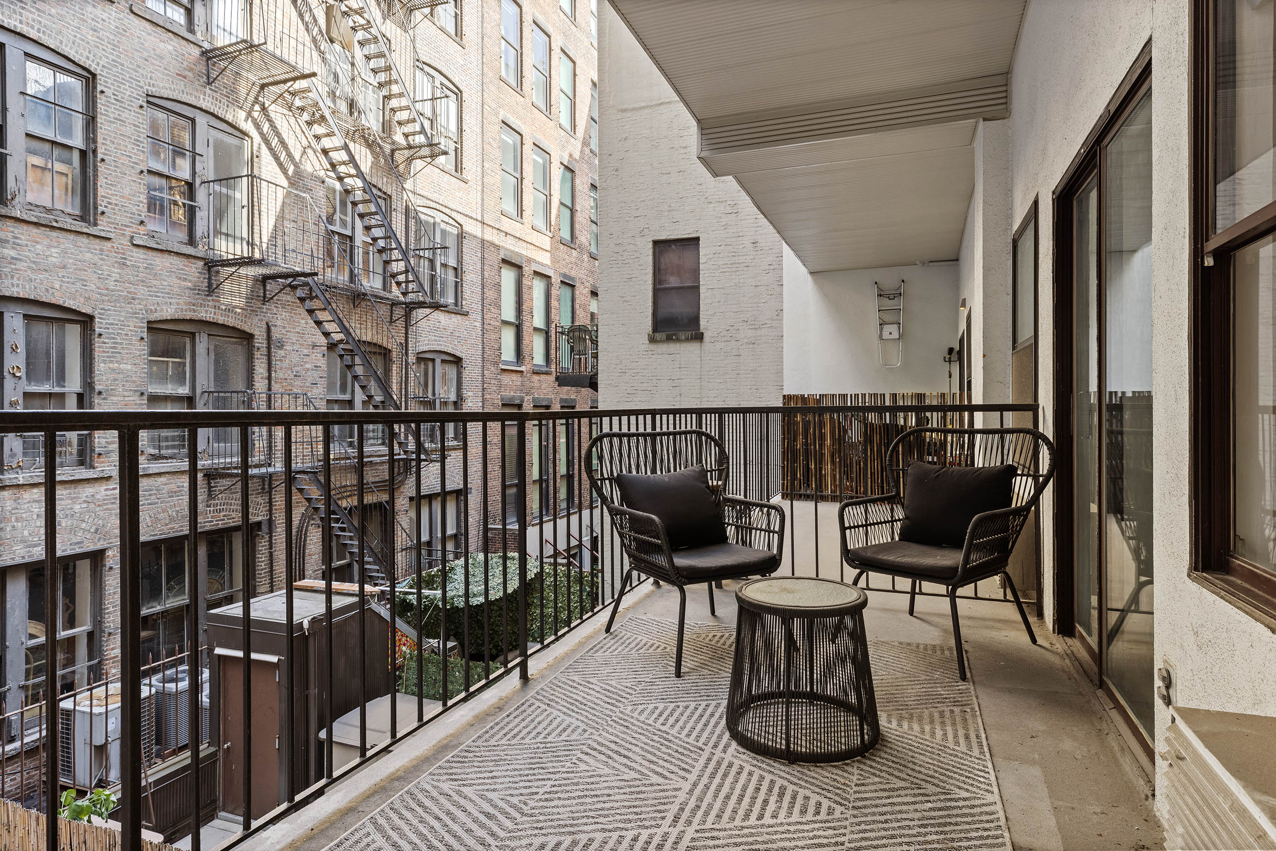 35 East 10th Street, Unit 3E Manhattan, NY 10003 - Photo 6 of 8 a view of balcony with chairs and wooden floor