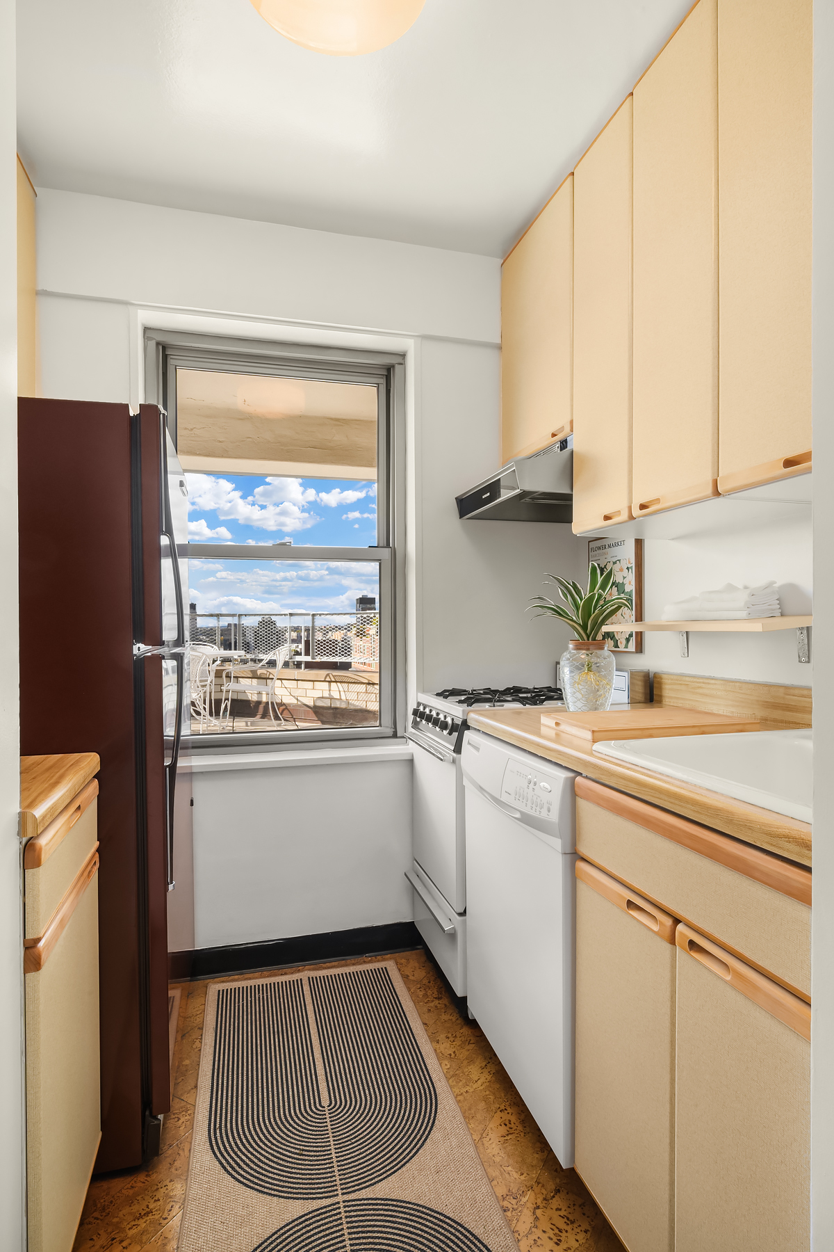 175 West 13th Street, Unit 19C Manhattan, NY 10011 - Photo 14 of 20 a kitchen with granite countertop white cabinets and white appliances