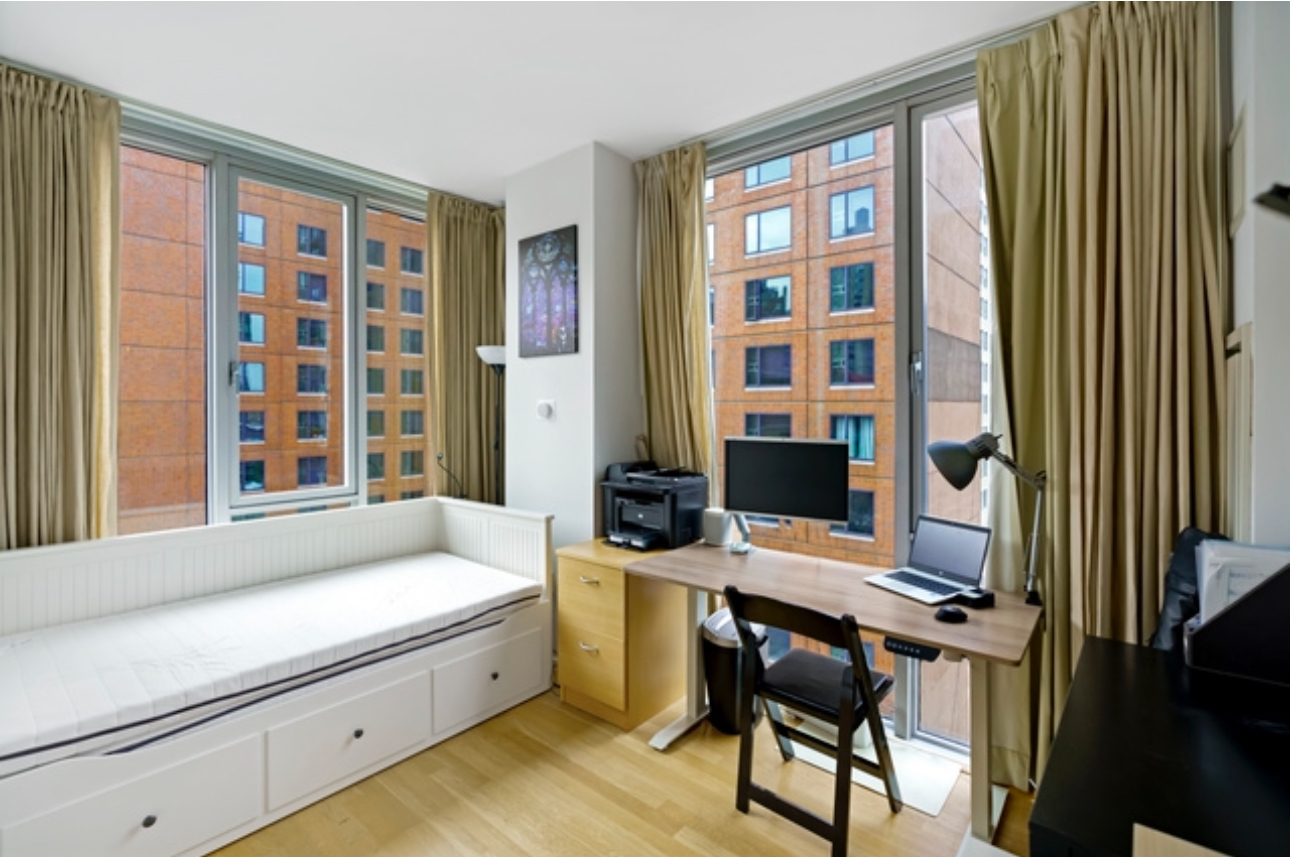 110 3rd Avenue, Unit 9B Manhattan, NY 10003 - Photo 8 of 14 a living room with furniture and a window