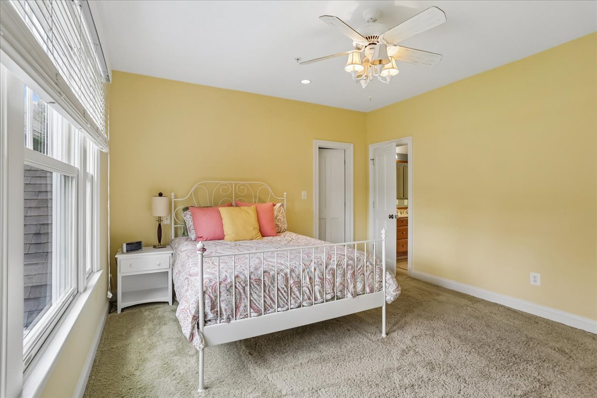 11736 Gainsborough Road Potomac, MD 20854 - Photo 71 of 90 a bedroom with a bed and a chandelier