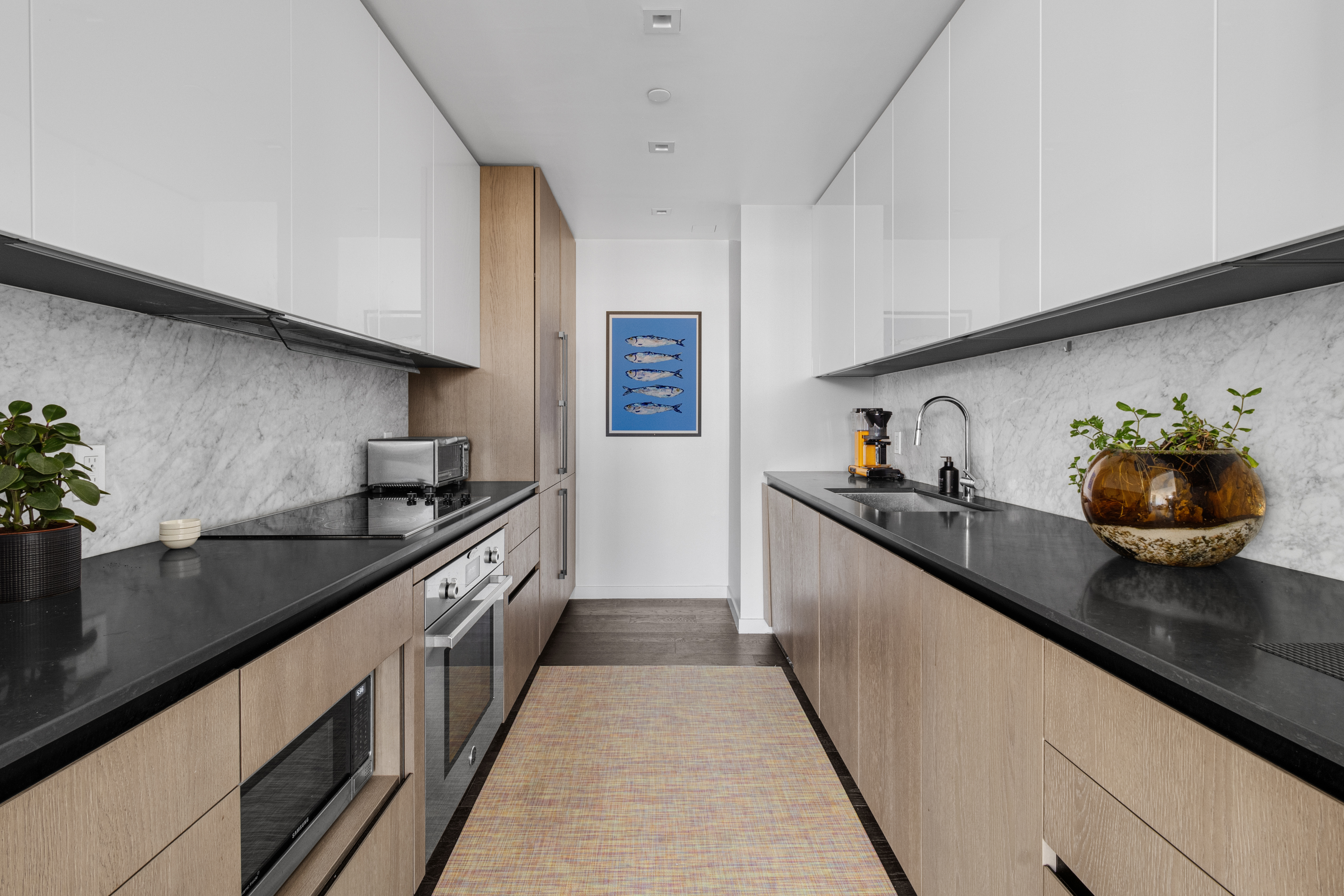302 East 96th Street, Unit 1103 Manhattan, NY 10128 - Photo 4 of 22 a kitchen with stainless steel appliances granite countertop a sink and stove