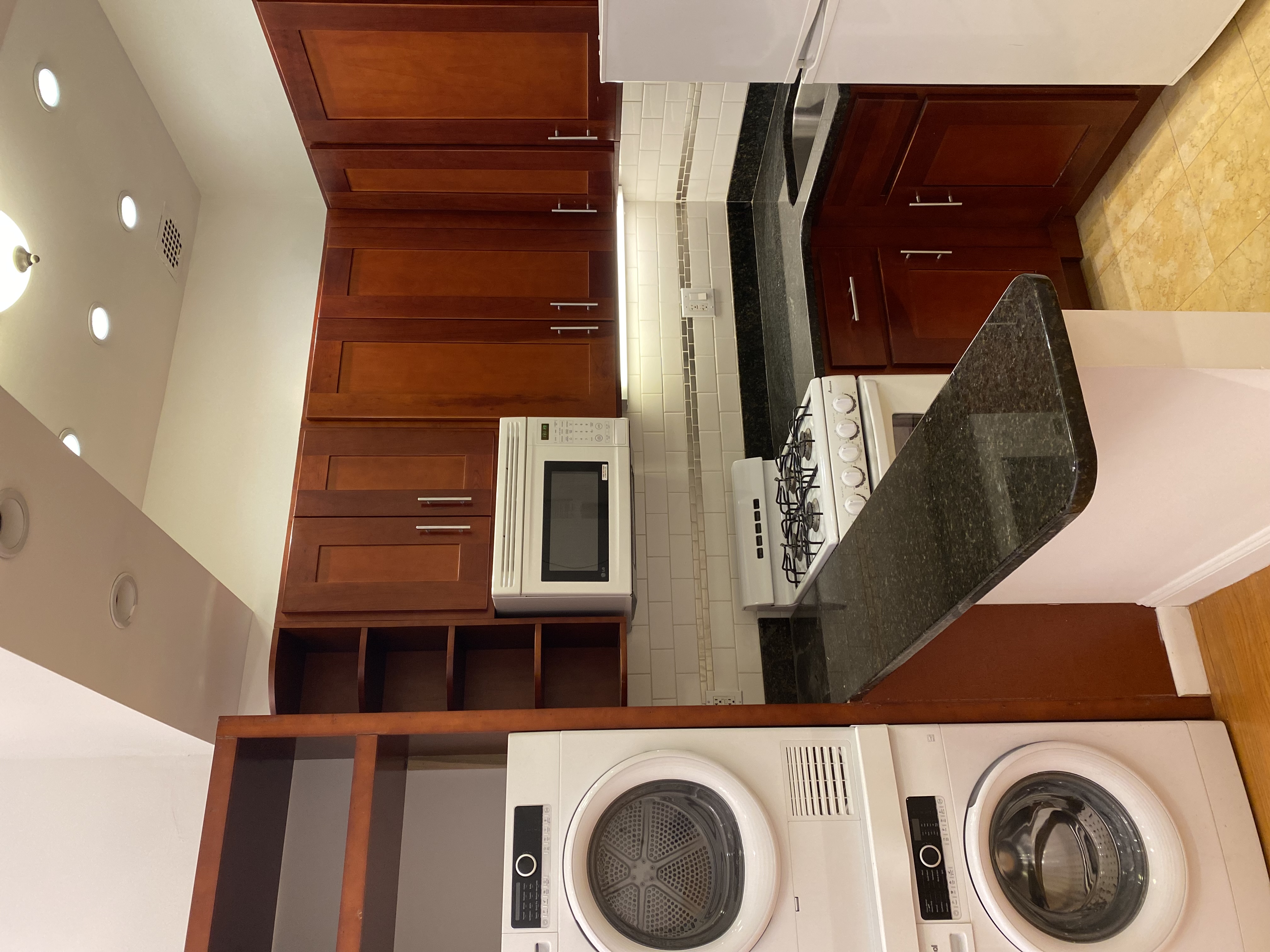a kitchen with kitchen island stainless steel appliances wooden cabinets and a sink