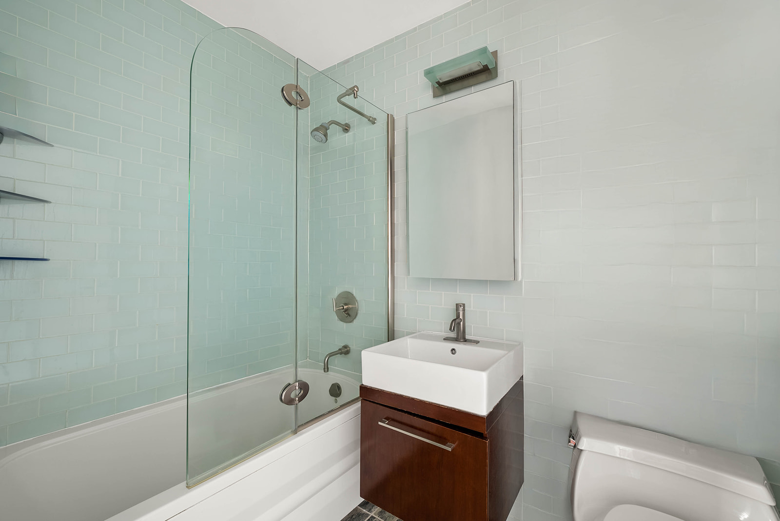 206 East 95th Street, Unit 10B Manhattan, NY 10128 - Photo 5 of 9 a bathroom with a sink a toilet and shower