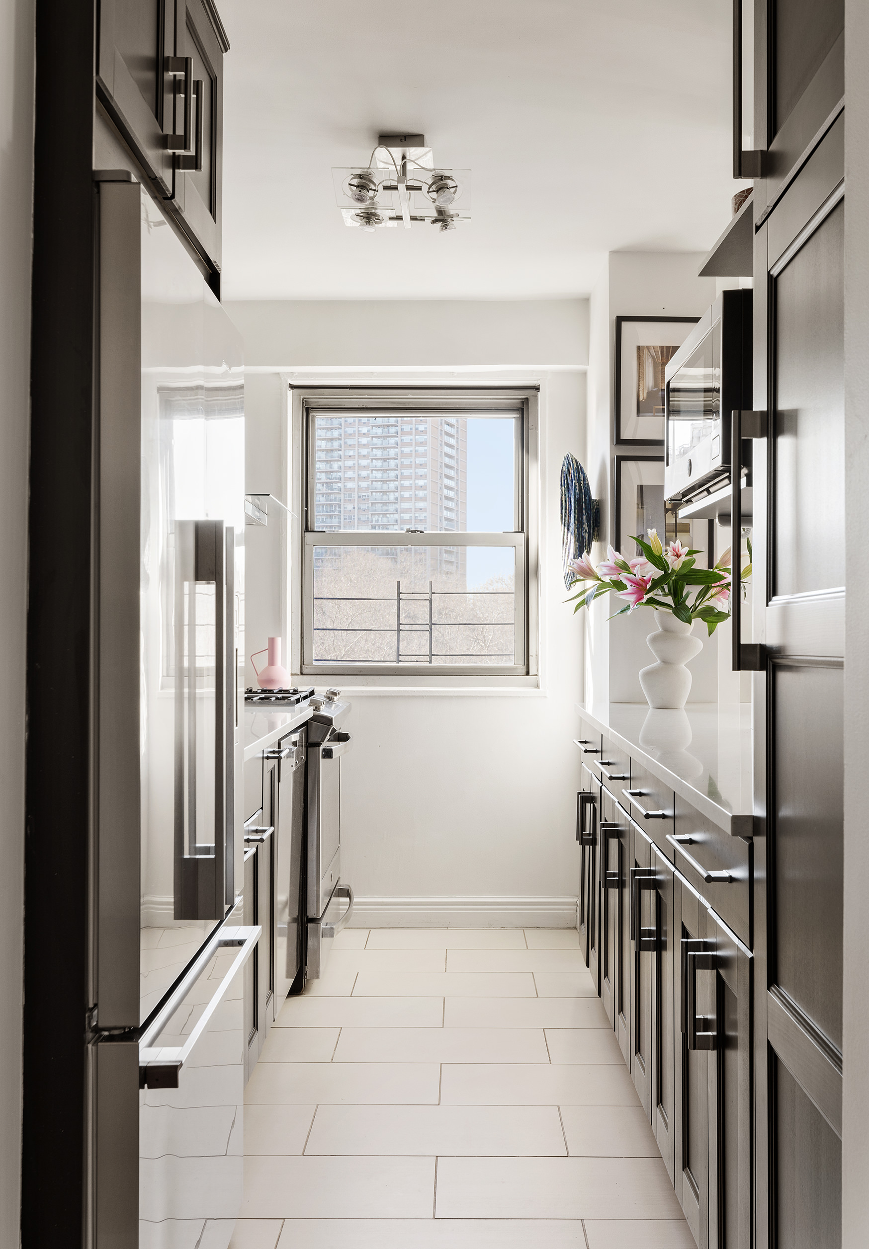 175 Adams Street, Unit 7A Brooklyn, NY 11201 - Photo 4 of 10 a kitchen with stainless steel appliances granite countertop a refrigerator and a sink