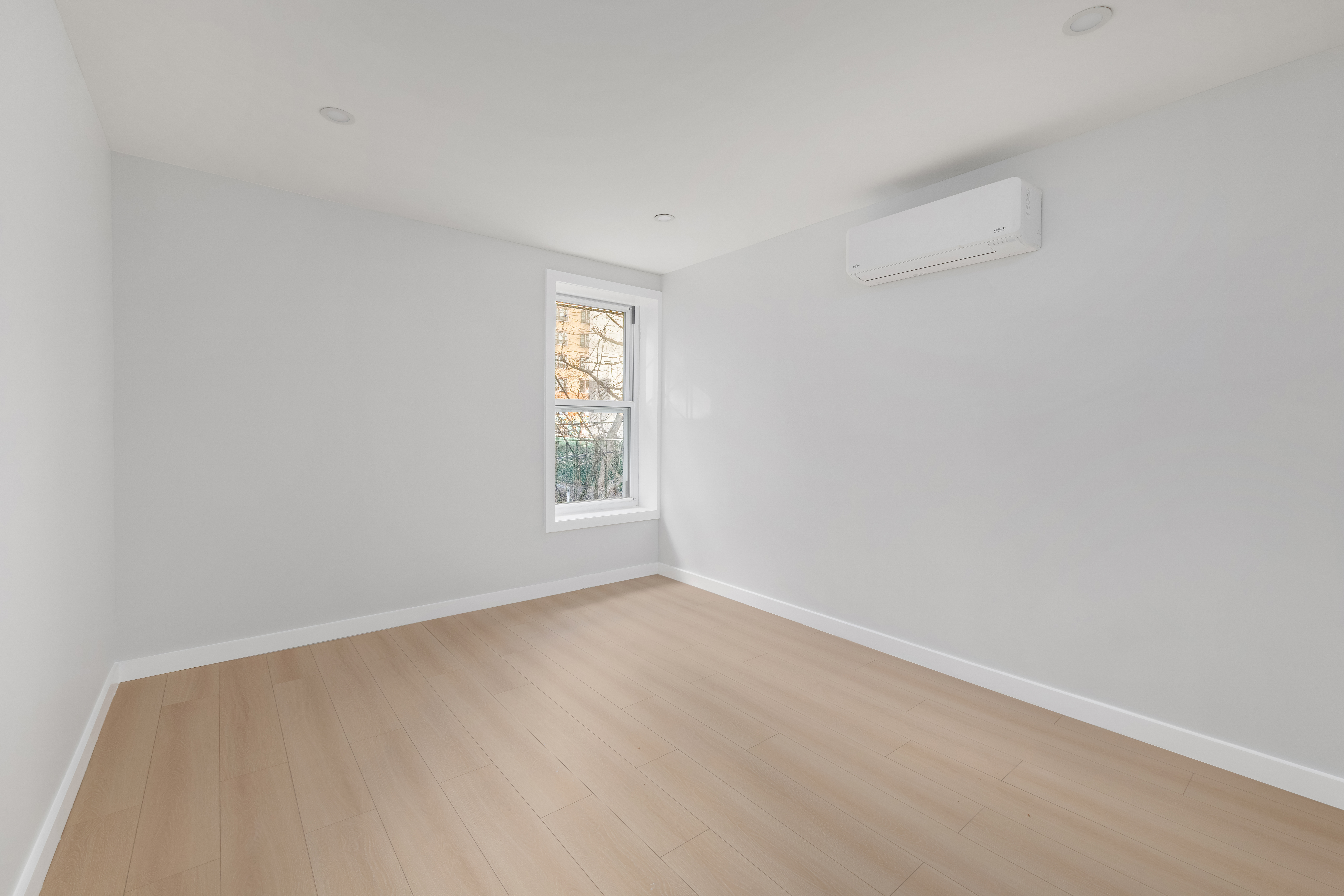 227 East 21st Street, Unit 2R Manhattan, NY 10010 - Photo 4 of 12 an empty room with windows