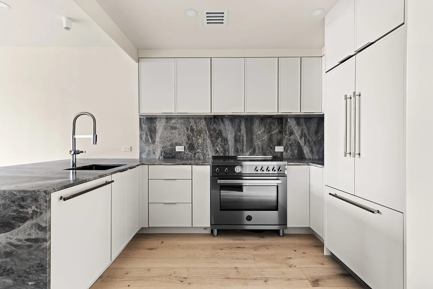 a kitchen with white cabinets stainless steel appliances and sink