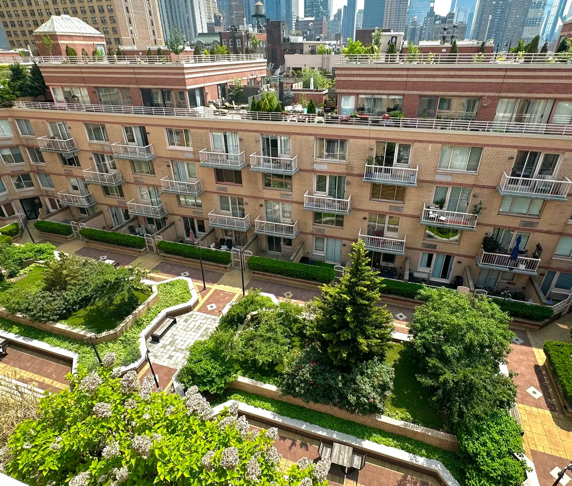 an aerial view of residential building with cars parked