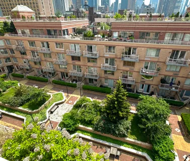 an aerial view of residential building with cars parked