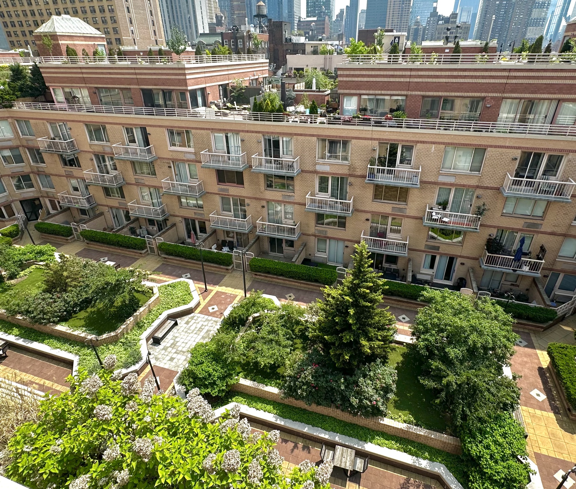 393 West 49th Street, Unit 5C Manhattan, NY 10019 - Photo 16 of 21 an aerial view of residential building with cars parked