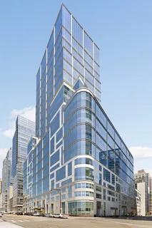 a black and white photo of a book and a white bed