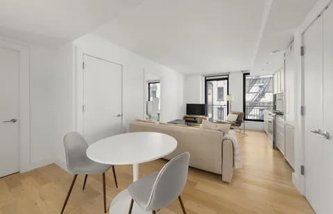 a living room with furniture a couch and a table