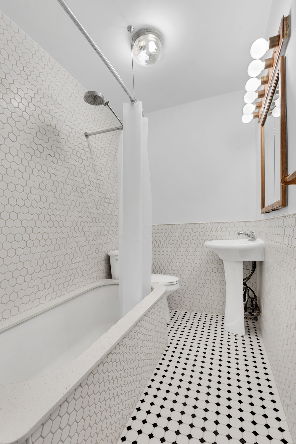 39 Clifton Place Brooklyn, NY 11238 - Photo 26 of 32 a bathroom with a sink a toilet a mirror and shower