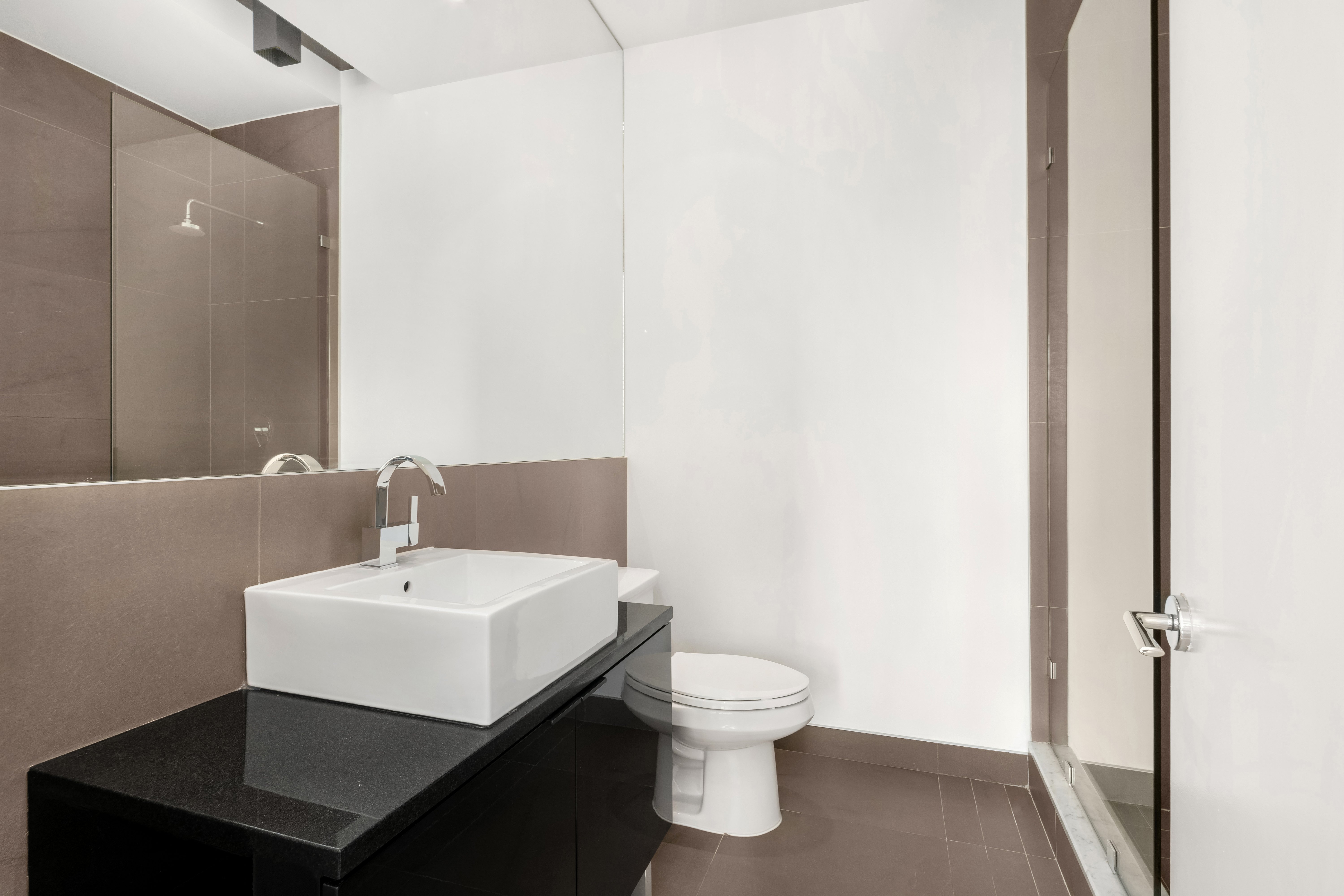 15 Roebling Street, Unit 2B Brooklyn, NY 11211 - Photo 4 of 9 a white toilet sitting next to a bathroom sink