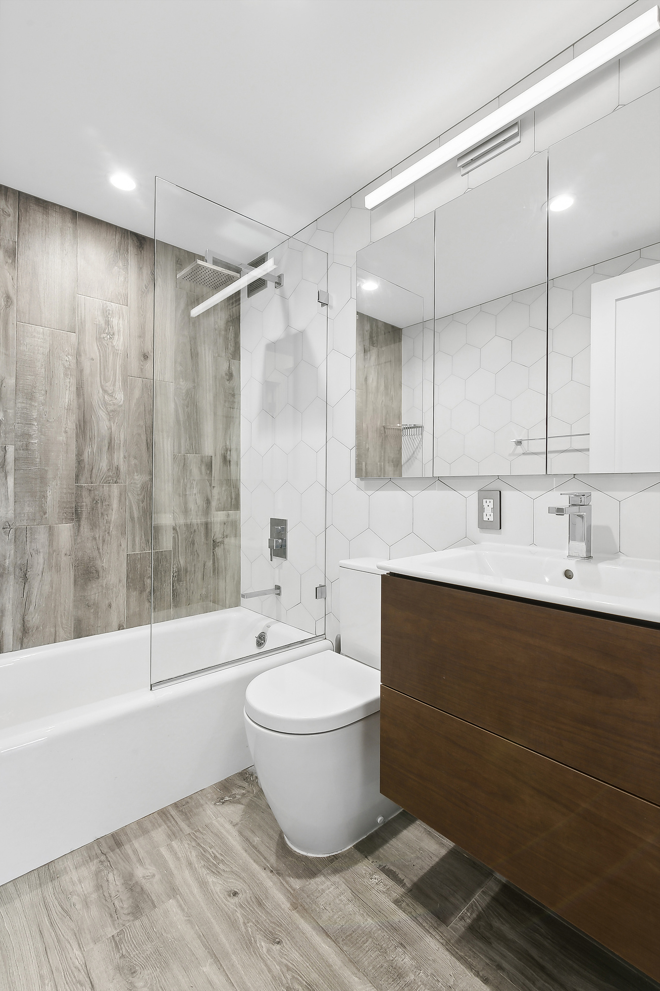 350 West 14th Street, Unit PHB Manhattan, NY 10014 - Photo 4 of 15 a bathroom with a bathtub shower sink mirror and toilet