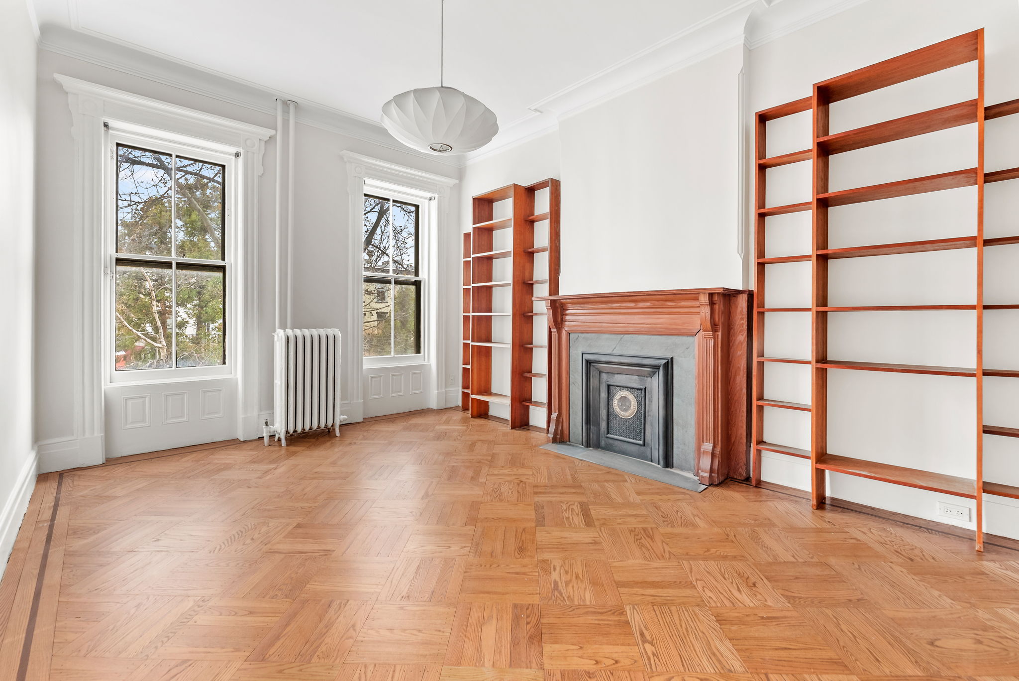 694 10th Street, Unit 2 Brooklyn, NY 11215 - Photo 10 of 22 a view of an empty room with a fireplace and a window